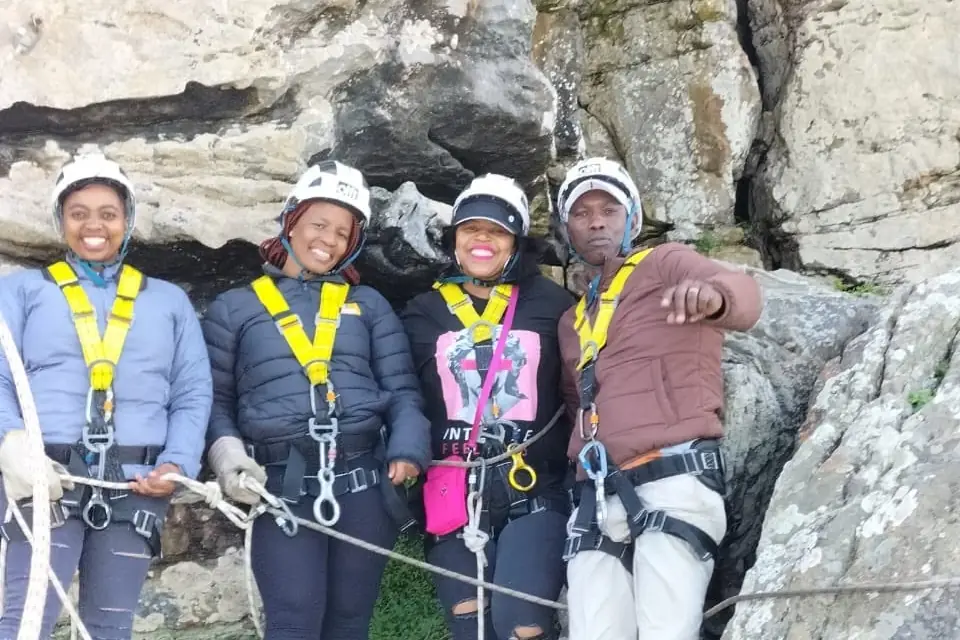 Guests in harnesses at the top of the abseil