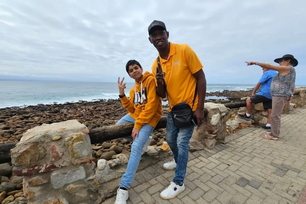 Jonas with guests on the rocks at the coast