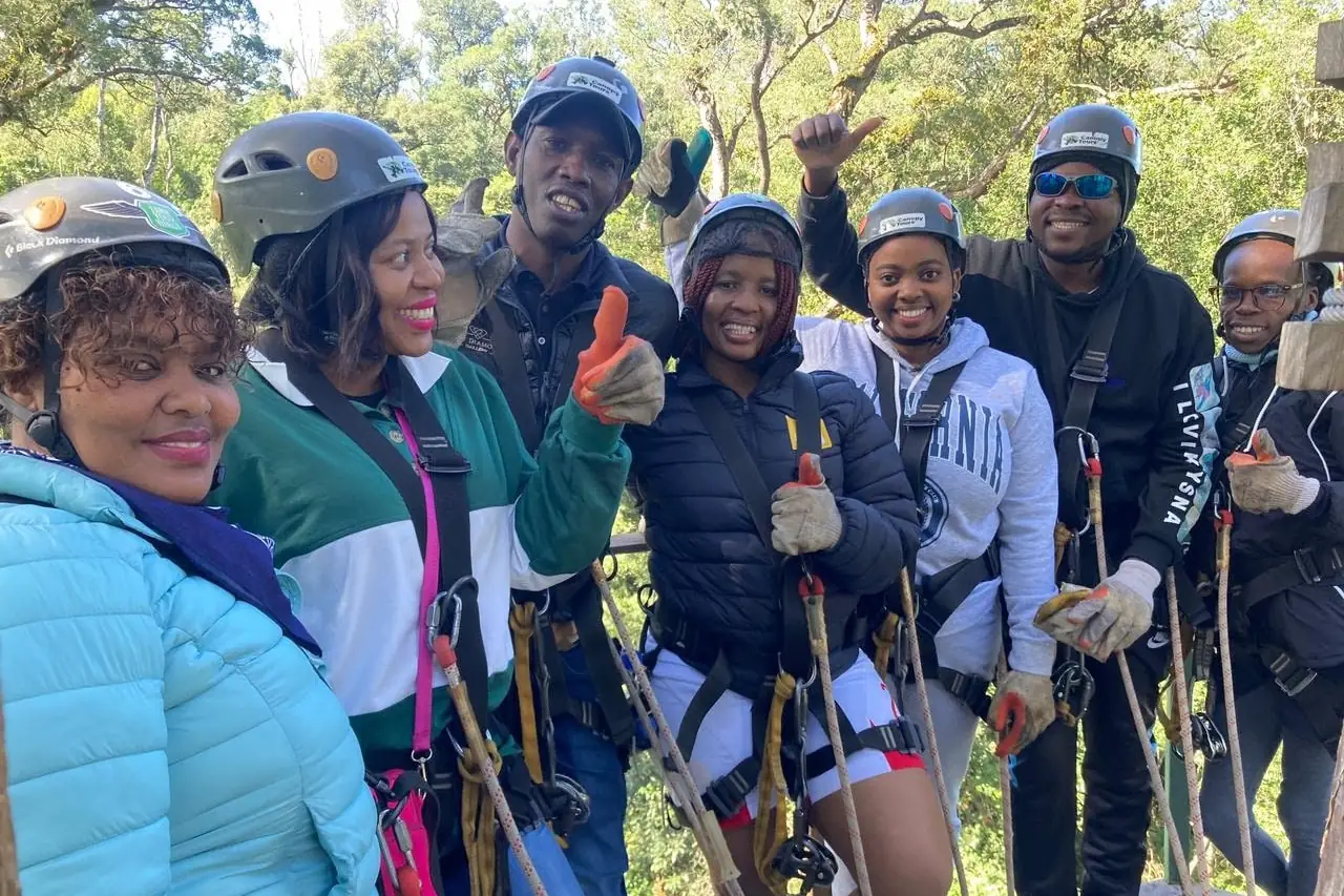 Guests kitted up in harnesses and helmets before an abseil