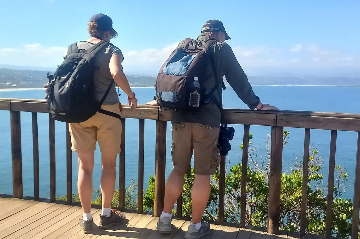 Two guests at a viewpoint looking out over Plettenberg Bay